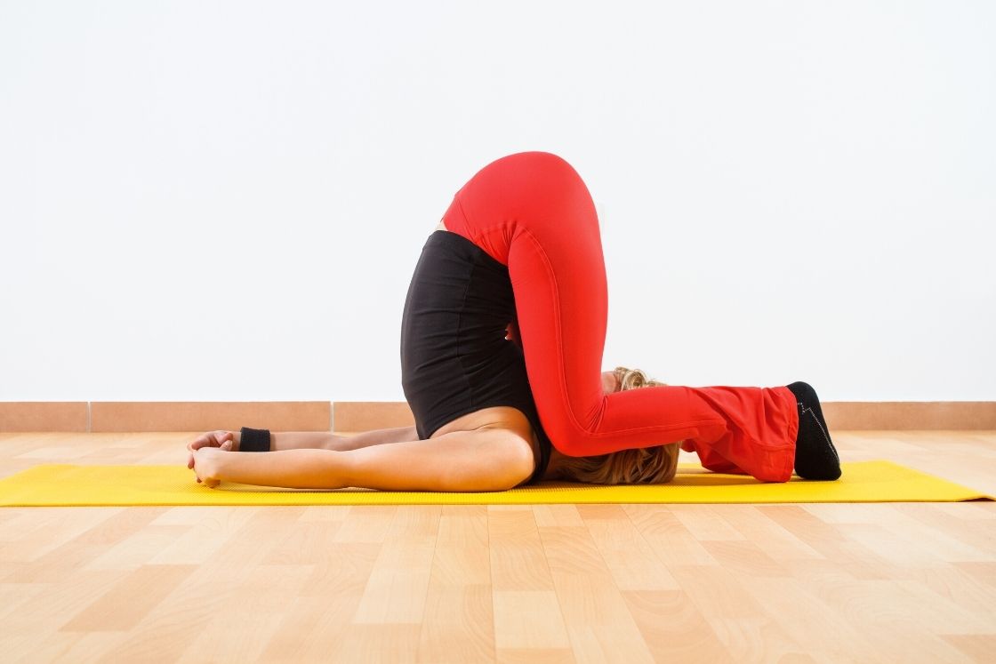 Karnapidasana - ear pressure pose