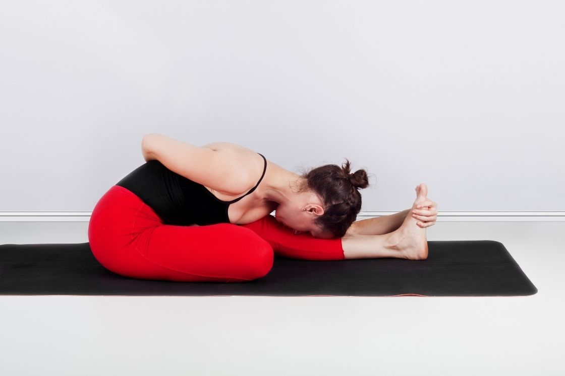 ardha baddha padma paschimottanasana (half-bound lotus forward bend pose)