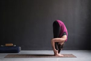 Uttanasana (Standing Forward Bend): Steps, Benefits, Variations & More