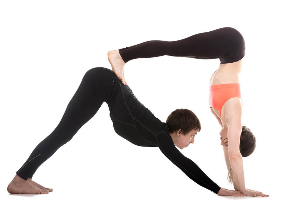 Premium Photo | A woman in sportswear practicing yoga performs dvipada  pithasana a halfbridge pose with a headstand