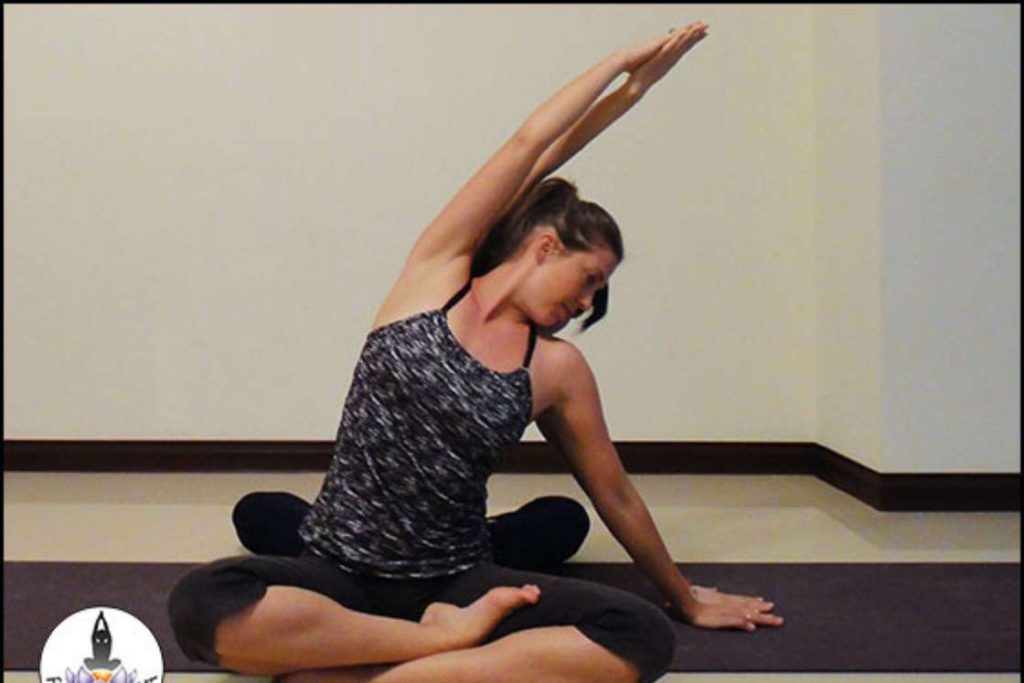 seated side bend partner yoga pose