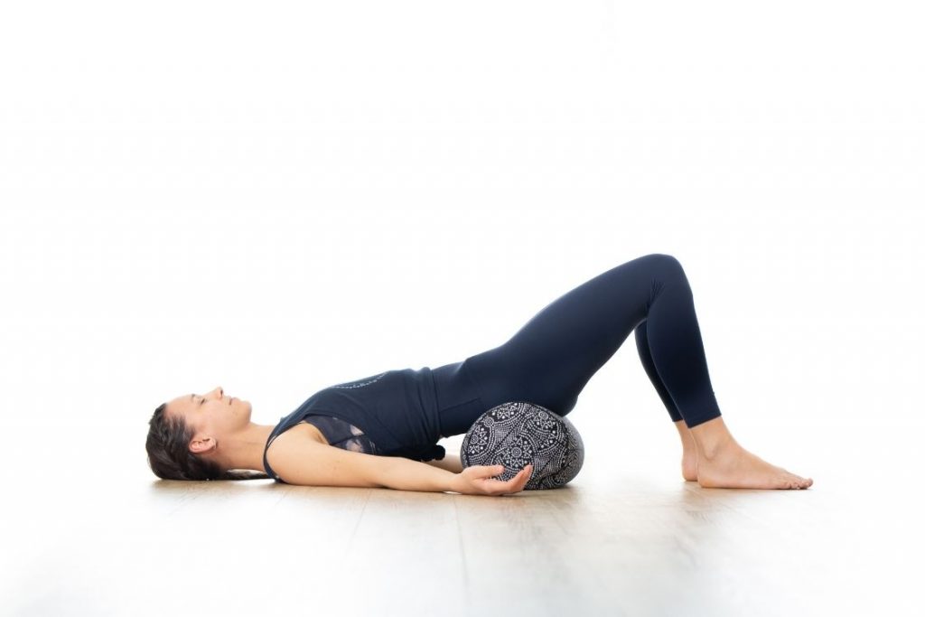 How to Use Bolster in Yoga Poses (and Benefits of Using It) - Fitsri Yoga