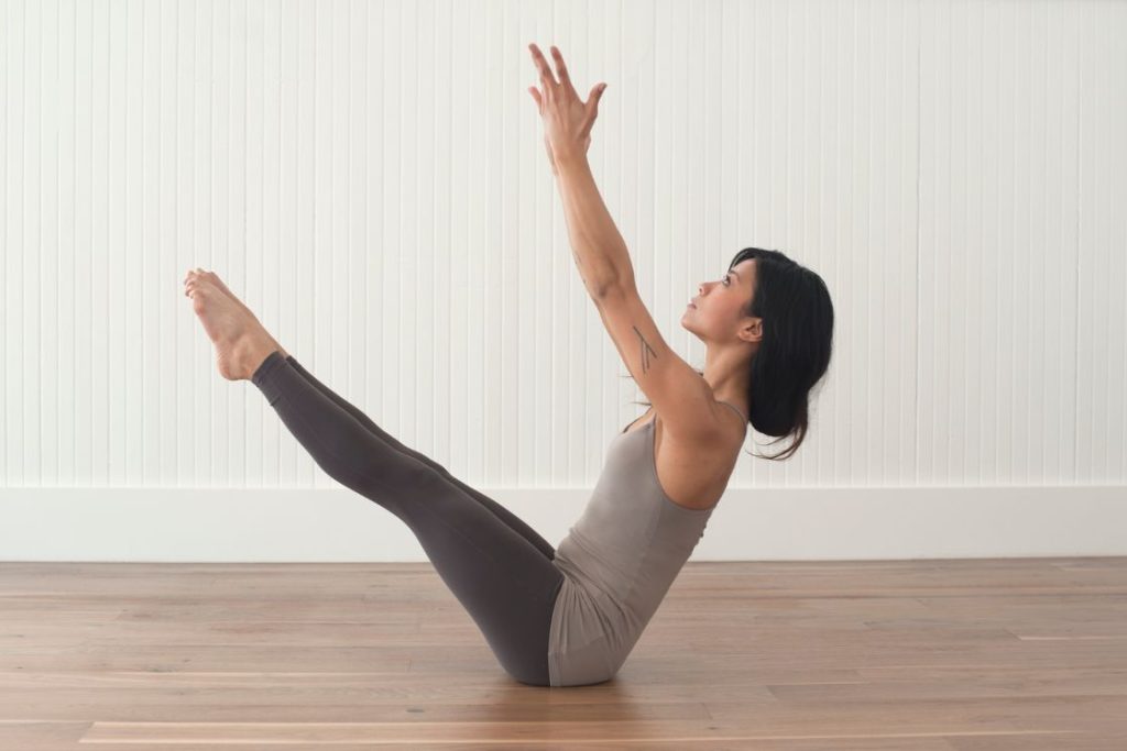 Full length portrait of young woman doing a yoga pose standing with one leg  raised up. Stock Photo | Adobe Stock