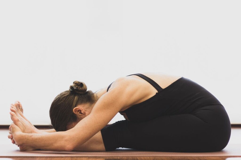 Seated forward bend Yoga Pose to Reduce Belly Fat